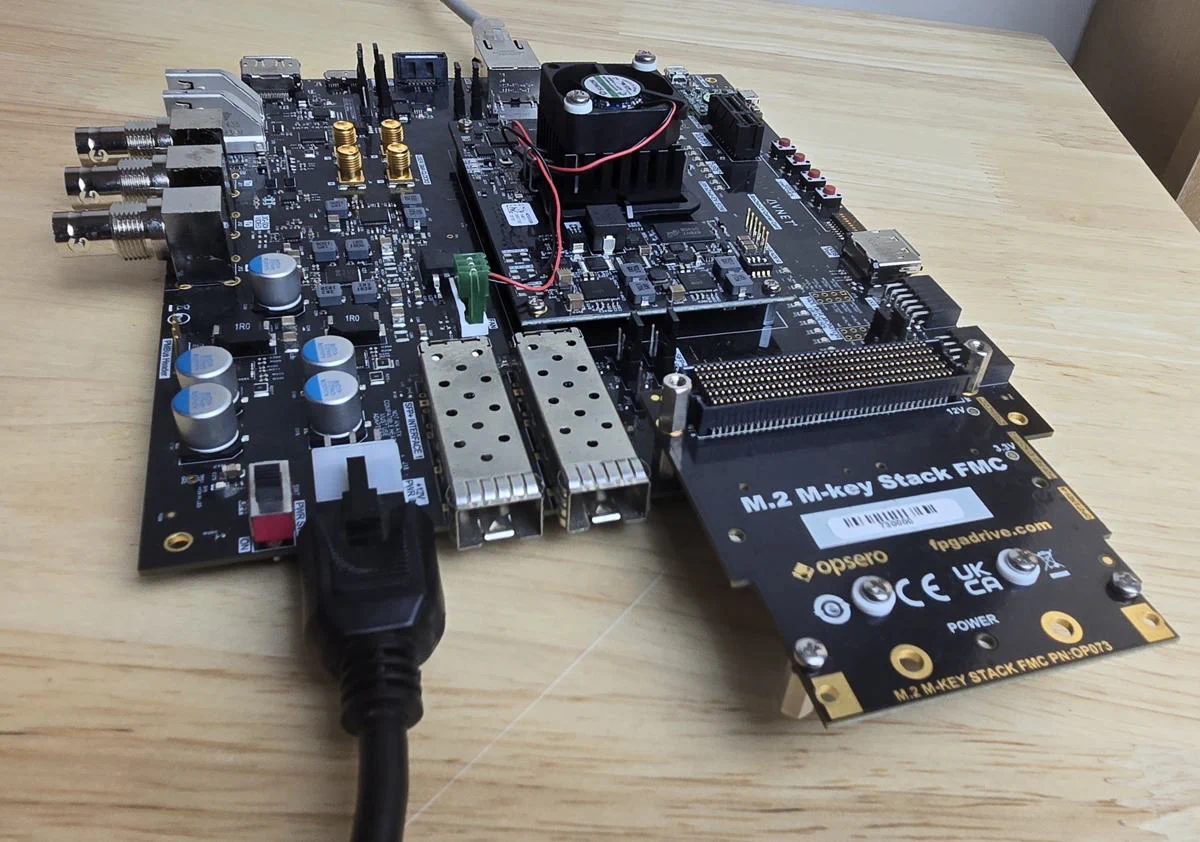 The FPGA Drive Recorder test setup: an UltraZed-EV Carrier Card with the M.2 M-key Stack FMC (OP073) in the FMC slot, carrying two Sabrent Rocket 2230 NVMe SSDs.